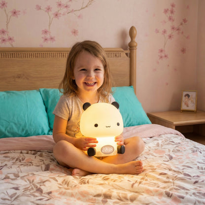 Child holding soft animal night light for kids bedtime comfort