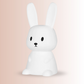 Child using bunny night light in kids bedroom at night