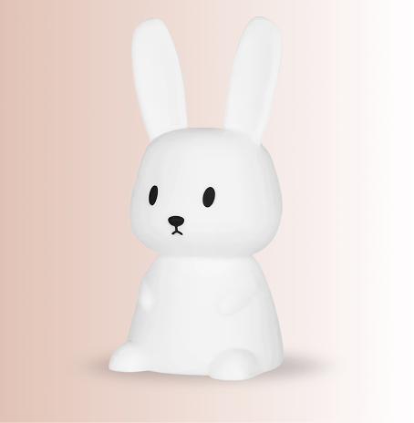 Child using bunny night light in kids bedroom at night